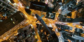 Bird eye photo of unmanned drone doing traffic management services around critical infrastructure